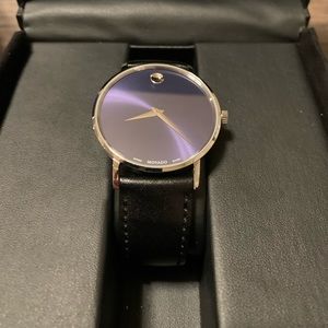 Movado Watch Silver and blue face with black leather band.